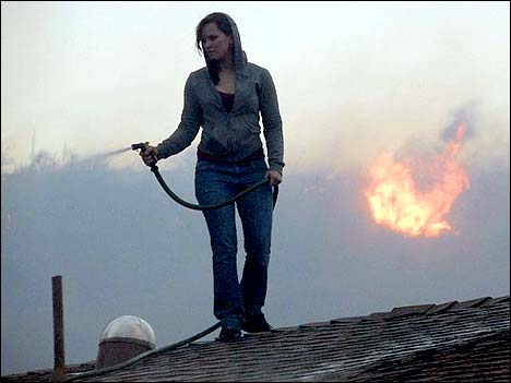 girl on roof fighting wildfires