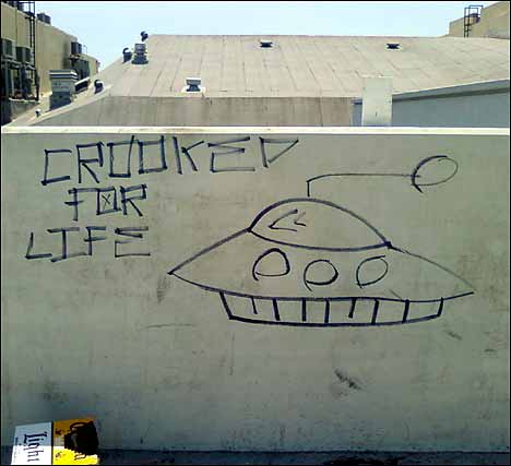 ufo graffiti corona light parking lot wall